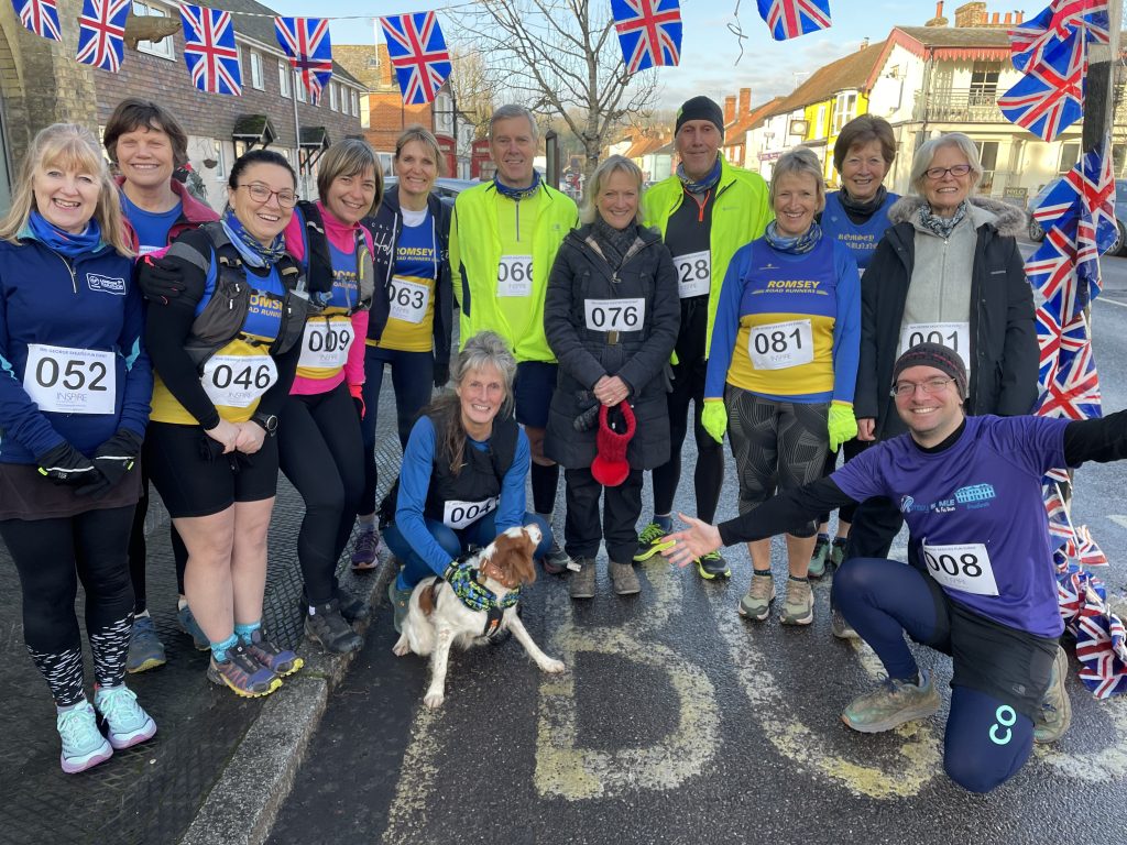 13 runners and a dog in running gear at the George Skeates Run